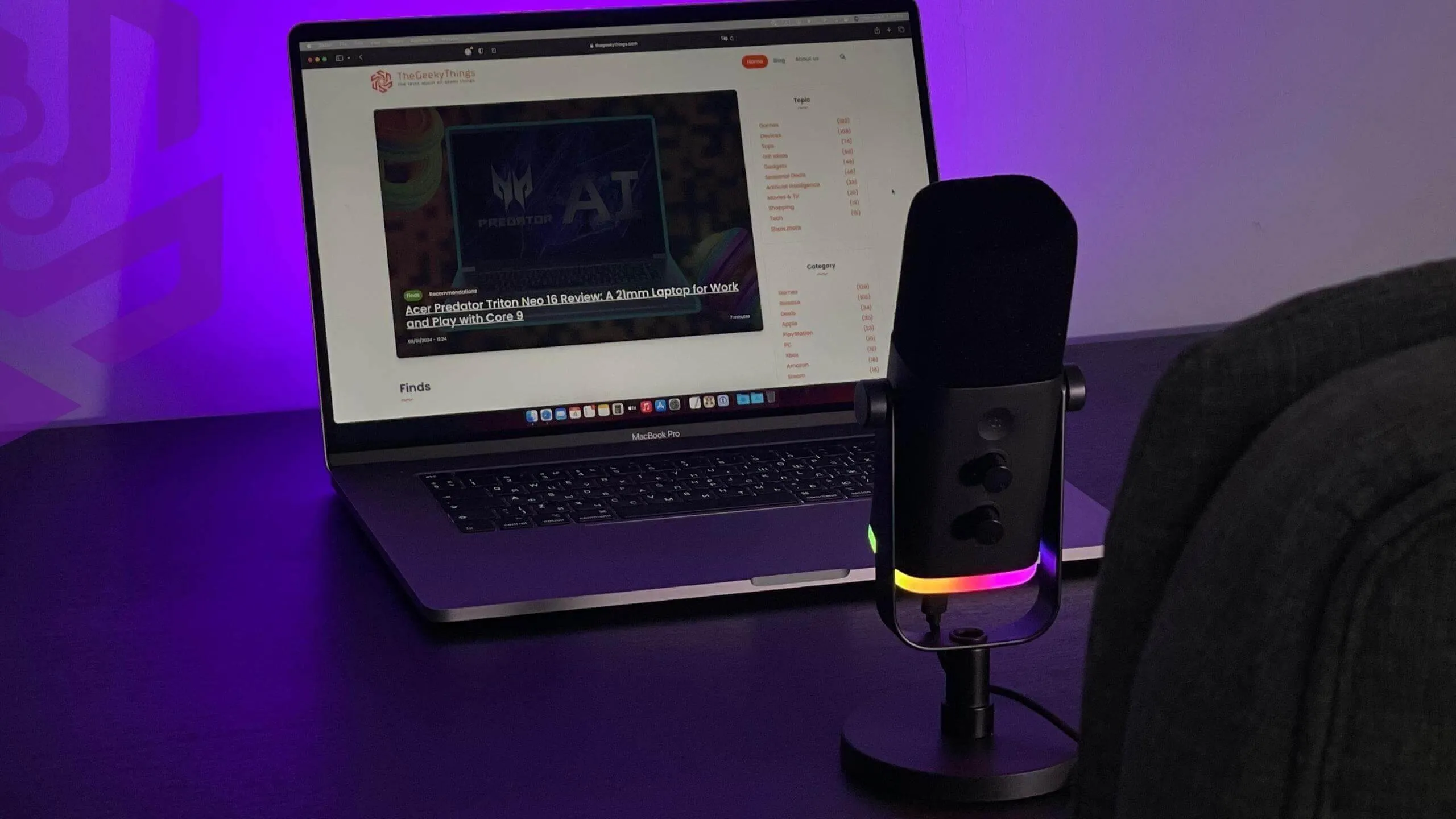 The Fifine AM8 with MacBook on the desk with purple background