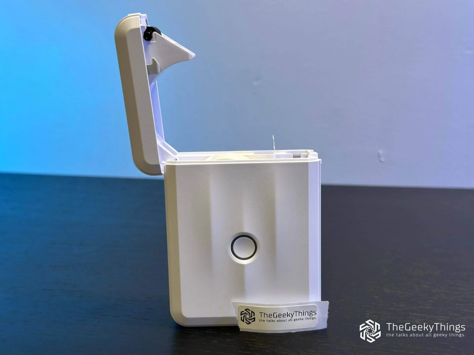 Niimbot D110 printer with open cover ready to load tape