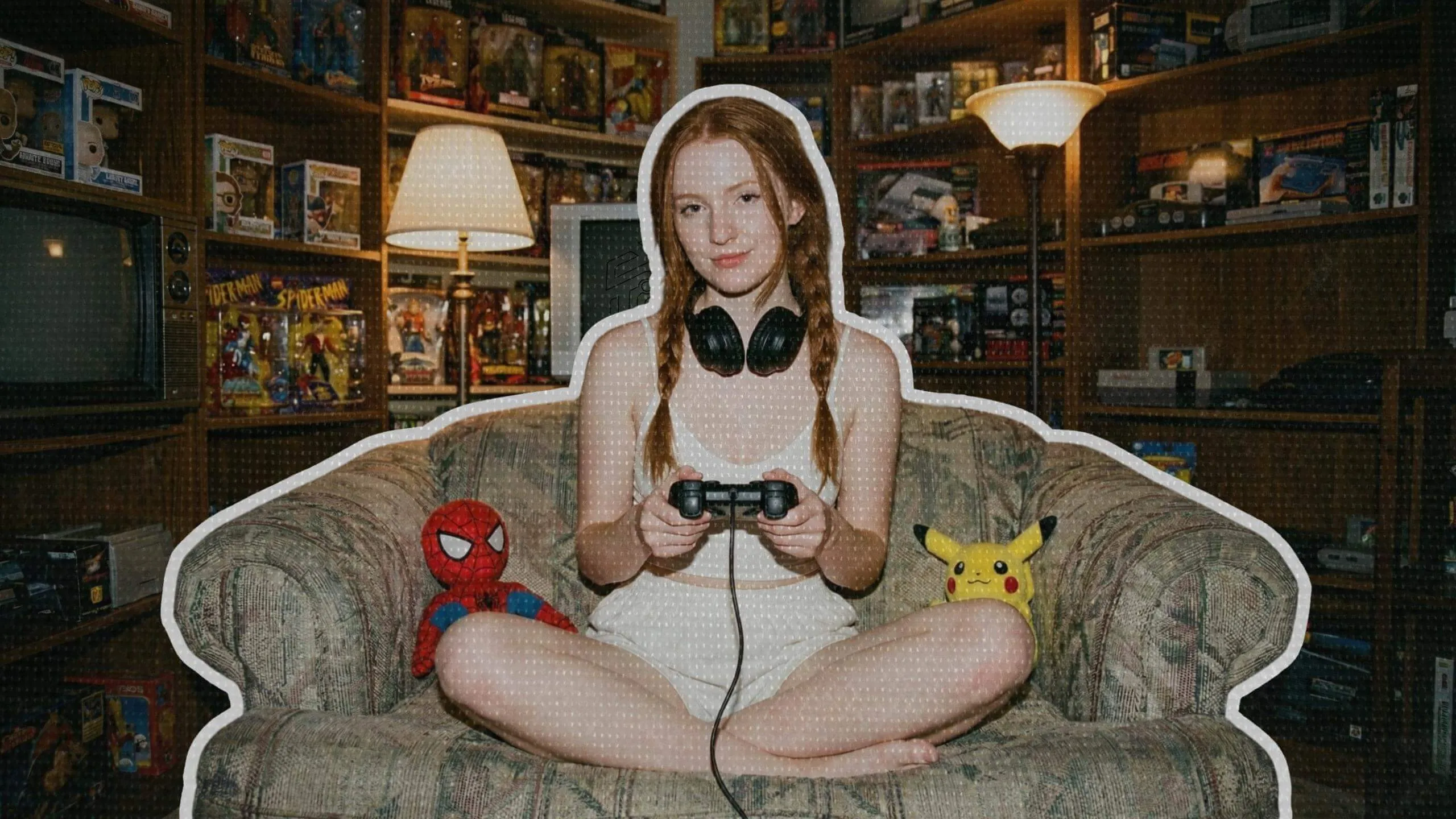 Red-haired girl gamer in a chair with her geeky collection of figures and games behind
