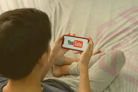 Man watches YouTube on his phone